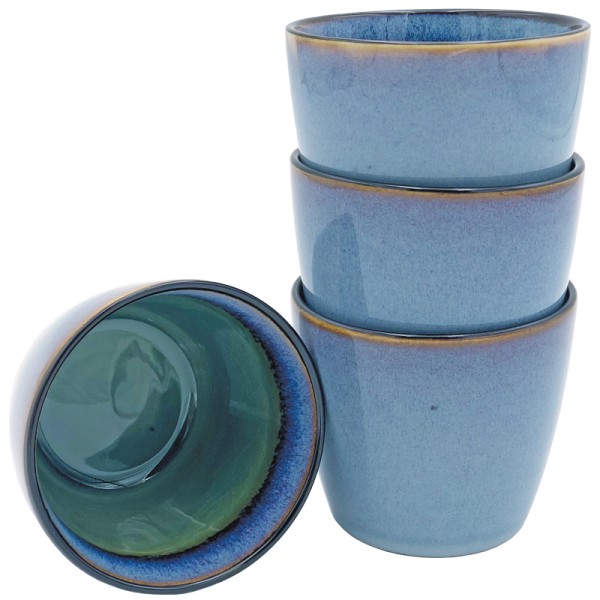 Blue cappuccino mugs stacked with one inverted to show green interior.