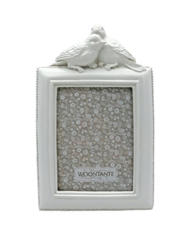 White picture frame with decorative birds on top in a vintage style.