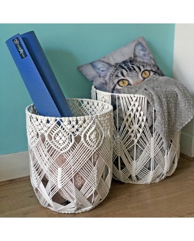 De macramé draadmand in tweetal bevatten een blauwe yogamat, een knusse grijze deken en een kussen met kattenprint. De macramé draadmand in tweetal bevatten een blauwe yogamat, een knusse grijze deken en een kussen met kattenprint.