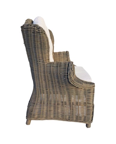 Side view of a rattan children's armchair featuring rounded armrests and a high back. Side view of a rattan children's armchair featuring rounded armrests and a high back.