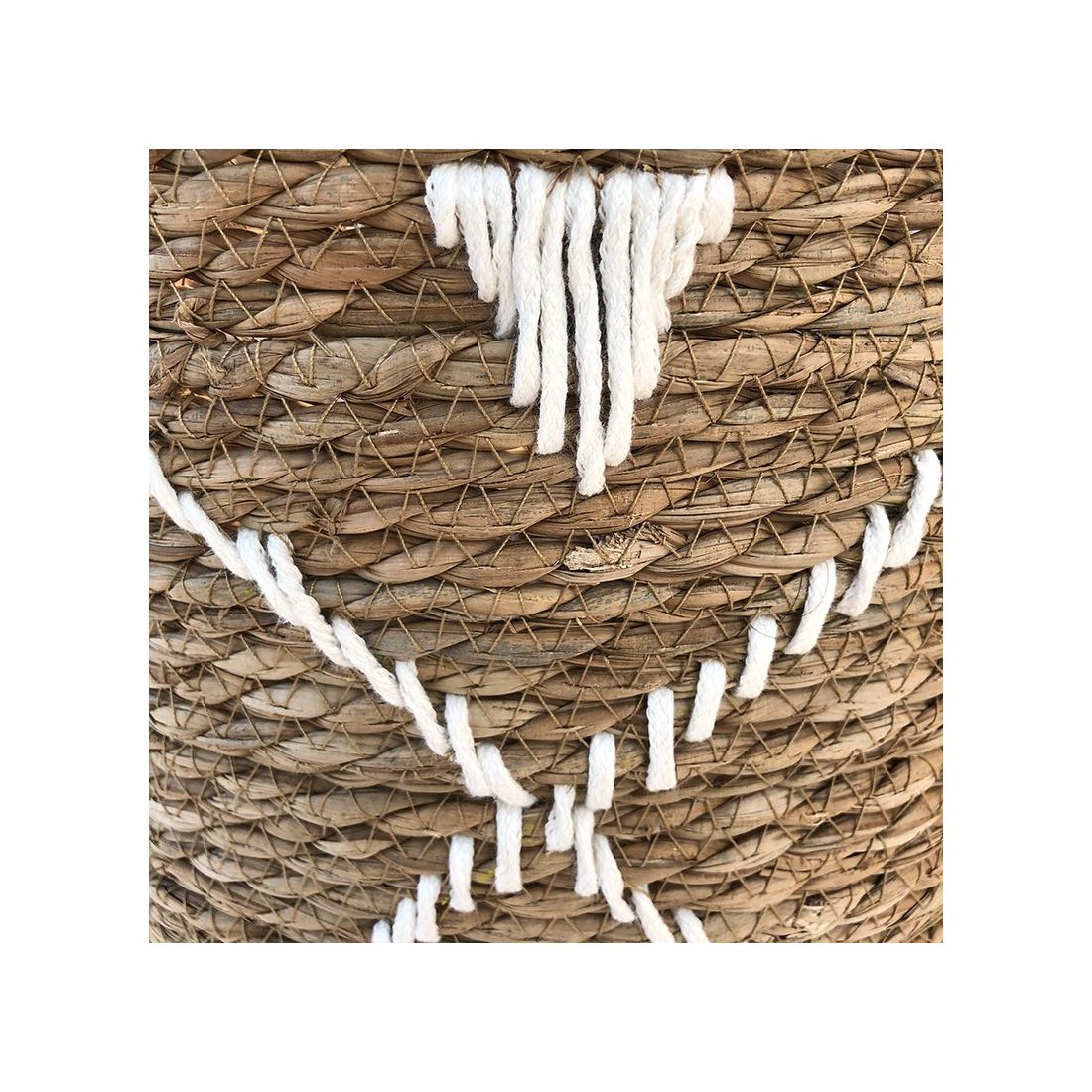 Close up of the geometric embroidery on the seagrass laundry basket. Close up of the geometric embroidery on the seagrass laundry basket.