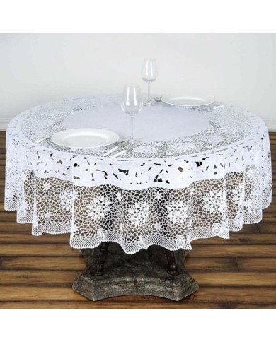 A round table adorned with a lace vinyl tablecloth, featuring two white plates and wine glasses.