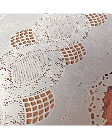 Close up detail of a white table runner made from vinyl with lace details.