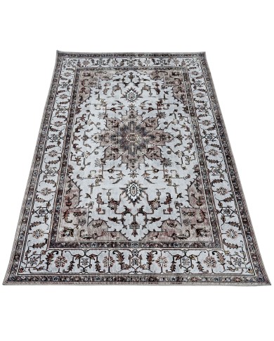 An ornate beige area rug patterned with a detailed border and central medallion design.