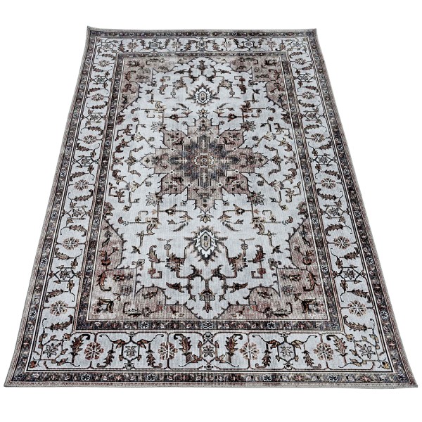 An ornate beige area rug patterned with a detailed border and central medallion design.