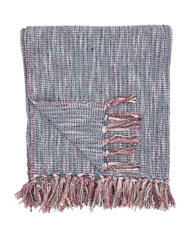 A folded woven cotton throw blanket with tassels on the edges.