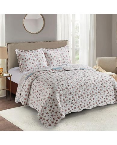 Het omkeerbare ontwerp van een bed sprei bloemen motief met kleine rozenprint en bijpassende kussens.