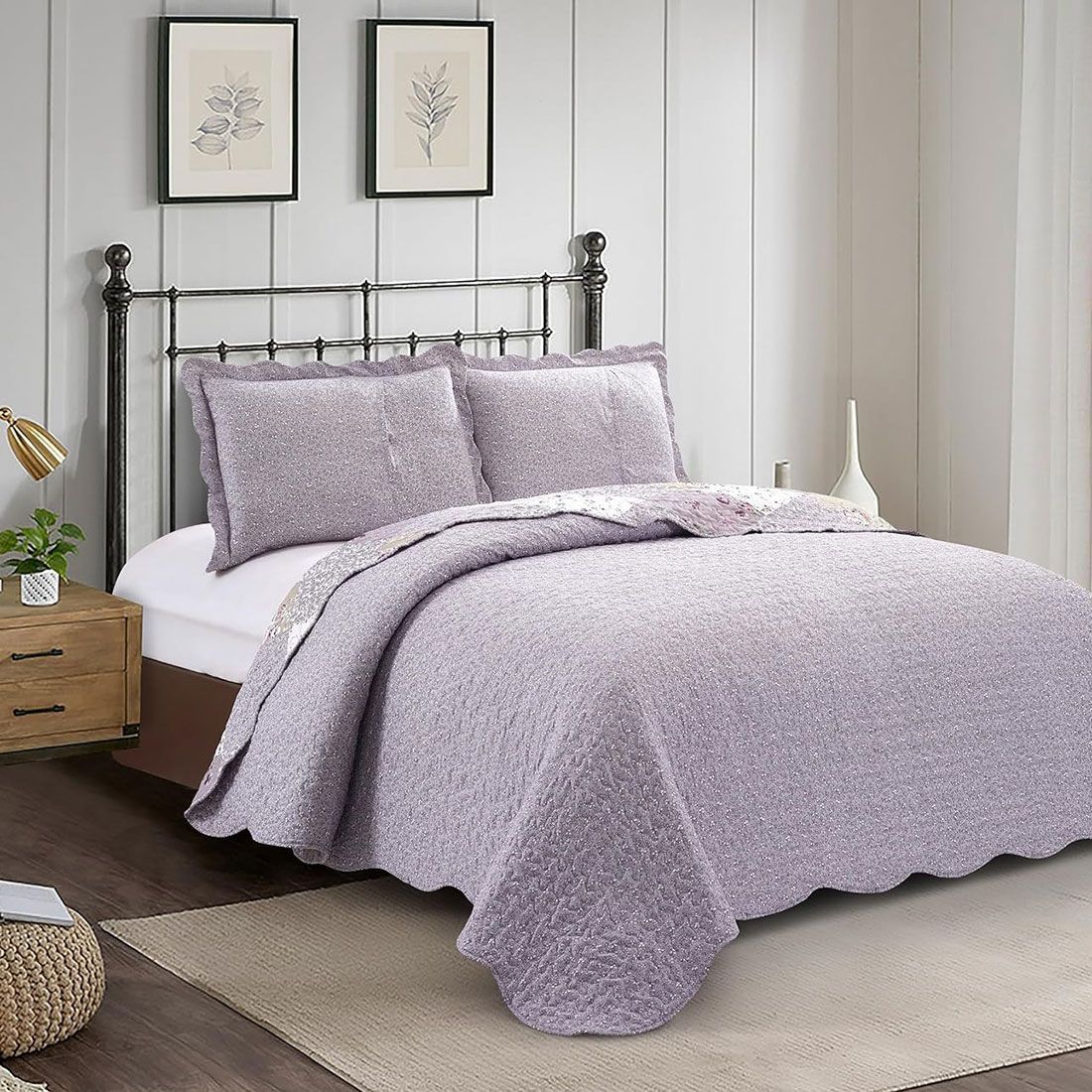 Showcasing the reverse design of Lavender Dream quilt, a white floral motif on a lilac background, paired with matching pillows. Showcasing the reverse design of Lavender Dream quilt, a white floral motif on a lilac background, paired with matching pillows.