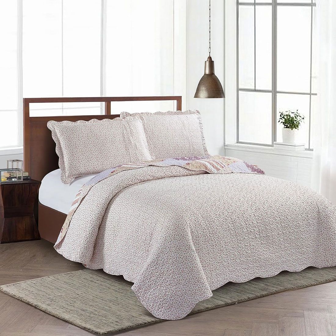 Showcasing the reverse design of Meadow Flowers quilt, delicate rosebuds on a cream background, paired with matching pillows. Showcasing the reverse design of Meadow Flowers quilt, delicate rosebuds on a cream background, paired with matching pillows.