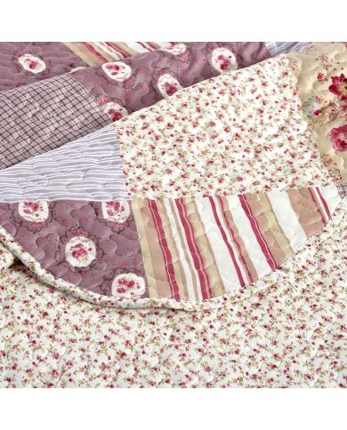 Close-up of patchwork quilt, showcasing muted pinks and mauve tones with a delicate stitching texture. Close-up of patchwork quilt, showcasing muted pinks and mauve tones with a delicate stitching texture.