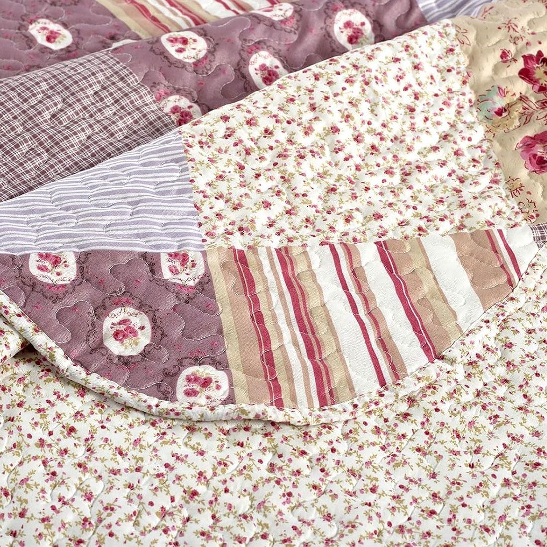 Close-up of patchwork quilt, showcasing muted pinks and mauve tones with a delicate stitching texture. Close-up of patchwork quilt, showcasing muted pinks and mauve tones with a delicate stitching texture.