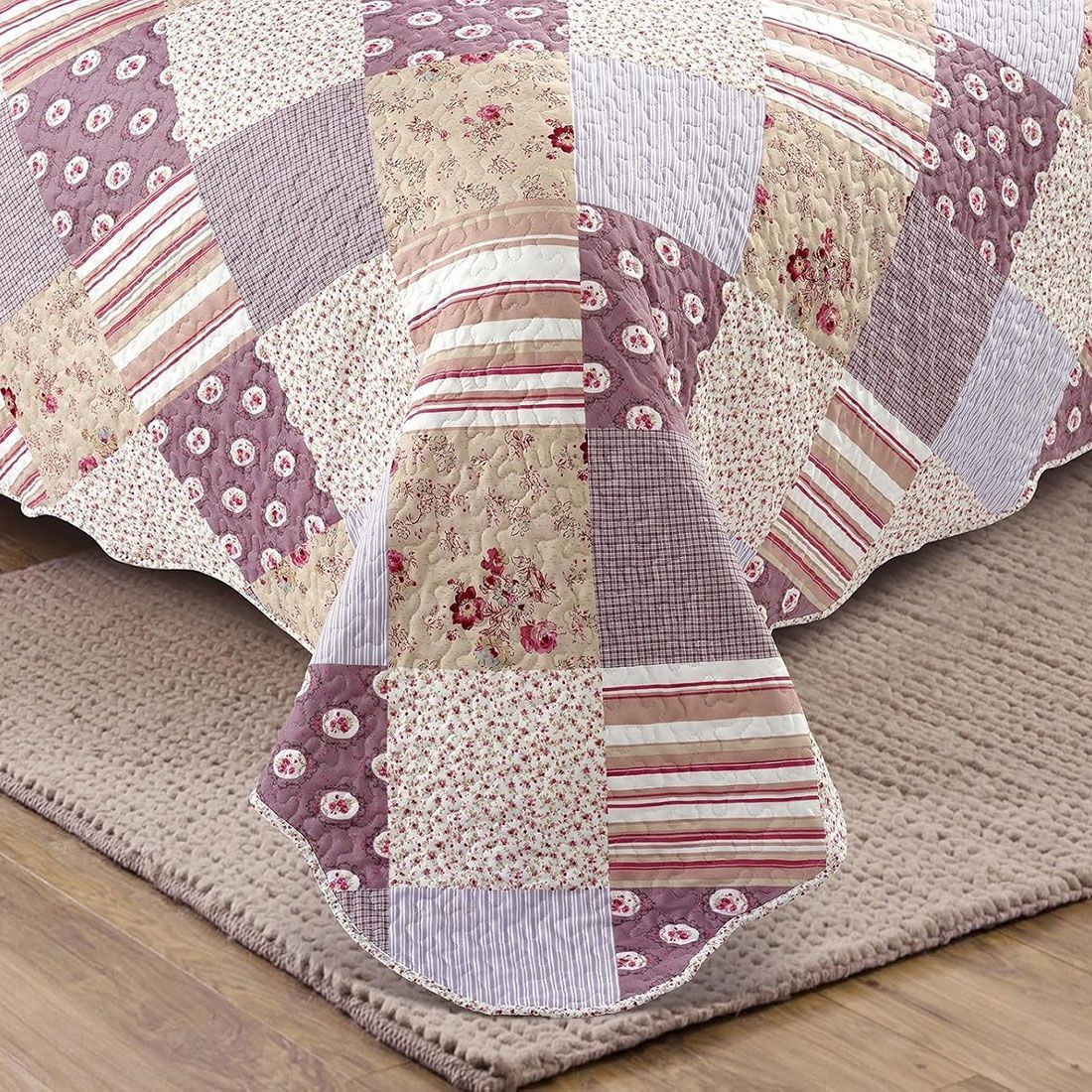 Detail of quilt showcasing floral, stripe, and check patch tiles, vermicelli stitching and scalloped edging. Detail of quilt showcasing floral, stripe, and check patch tiles, vermicelli stitching and scalloped edging.