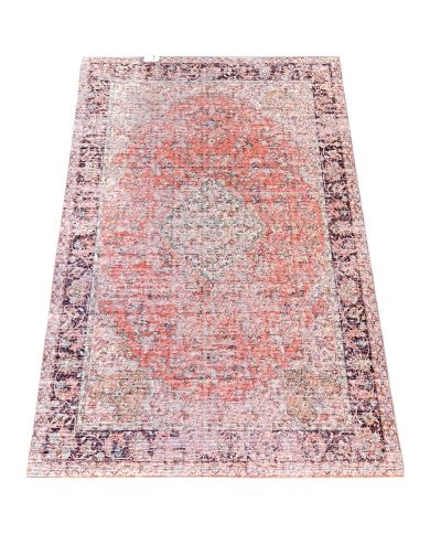 Vintage rug with a distressed pattern in shades of orange and beige. Vintage rug with a distressed pattern in shades of orange and beige.