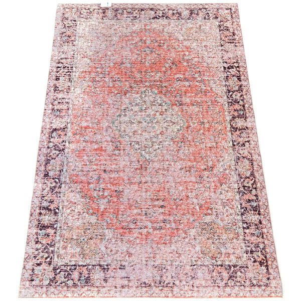 Vintage rug with a distressed pattern in shades of orange and beige.