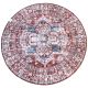 Round vintage rug with intricate blue and dark orange patterns on a neutral background.