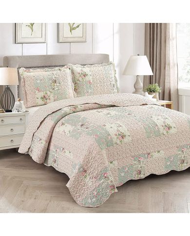 Elegant bedroom with a Rosebud floral quilt set on bed, matching pillows, and classic decor.