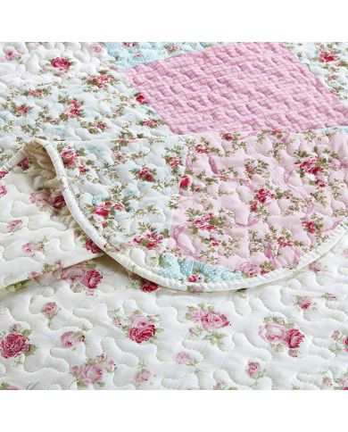 Close-up of a pink quilt, showcasing pink patchwork with a delicate stitching texture. Close-up of a pink quilt, showcasing pink patchwork with a delicate stitching texture.