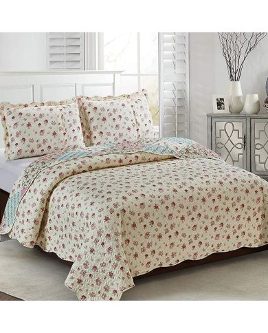 Showcasing the reverse design of the Spring Floral quilt, a small pink rose print, paired with matching pillows. Showcasing the reverse design of the Spring Floral quilt, a small pink rose print, paired with matching pillows.