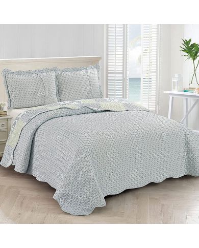 Showcasing the reverse design of the blue quilt, a diamond pattern with a small floral print, paired with matching pillows. Showcasing the reverse design of the blue quilt, a diamond pattern with a small floral print, paired with matching pillows.