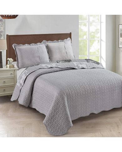 Showcasing the Toile de Jouy patchwork design of the grey quilt, paired with matching pillows. Showcasing the Toile de Jouy patchwork design of the grey quilt, paired with matching pillows.