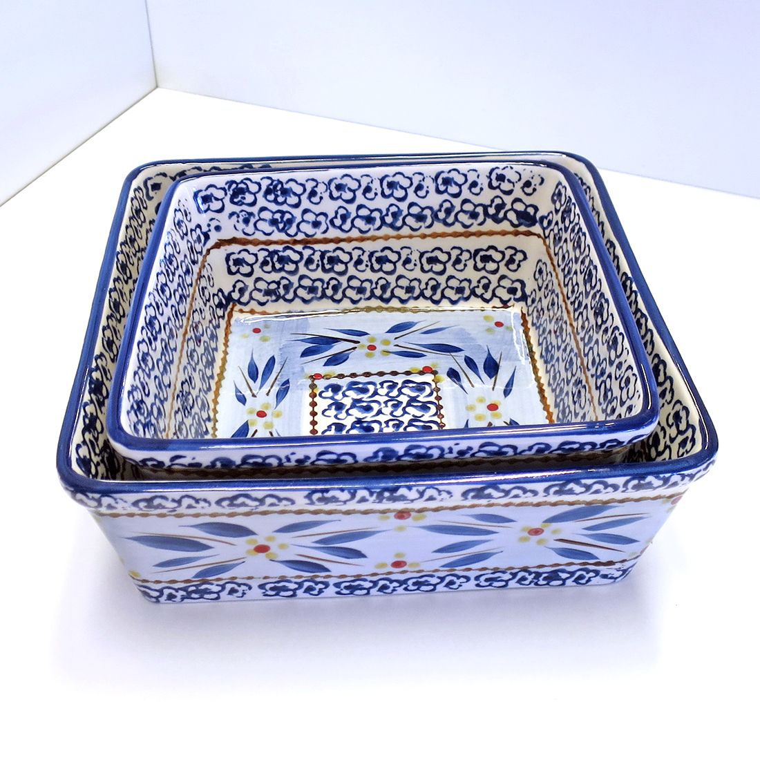 Close-up of a square oven dish featuring intricate blue and yellow floral patterns.