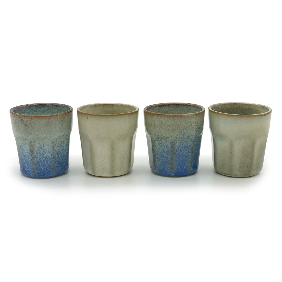 Four handmade espresso cups with subtle blue and grey reactive glazes.