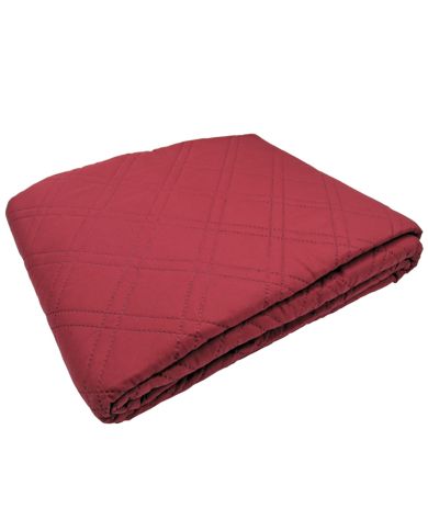 Folded red bedspread, showcasing a double diamond pattern. Folded red bedspread, showcasing a double diamond pattern.