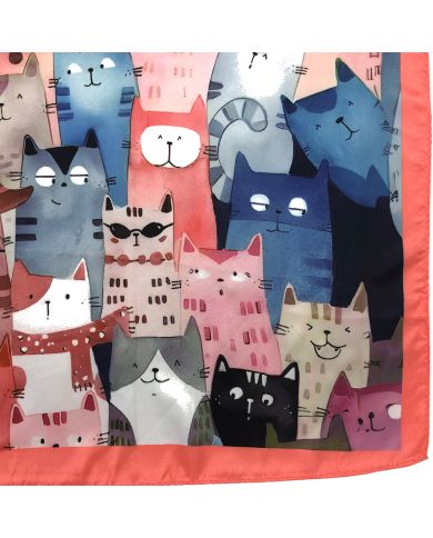 Close up of the satin scarf featuring a whimsical pattern of stylized cats. Close up of the satin scarf featuring a whimsical pattern of stylized cats.