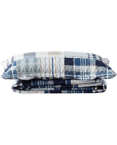 A stack of patchwork pillows featuring blue stripes and squares throughout.