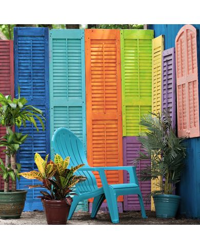 A vibrant outdoor scene featuring colourful wooden shutter panels and lush green plants in decorative pots. A vibrant outdoor scene featuring colourful wooden shutter panels and lush green plants in decorative pots.