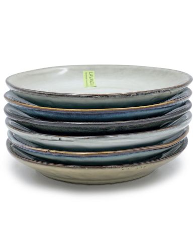 A stack of six stylish petit four plates in various colours.