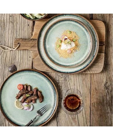 A rustic wooden table features two bohemian dinner plates. A rustic wooden table features two bohemian dinner plates.