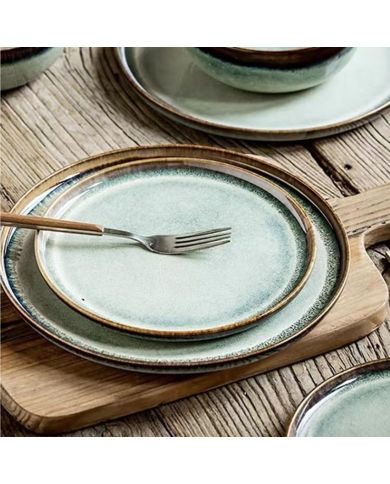 A rustic wooden table features two bohemian side plates. A rustic wooden table features two bohemian side plates.