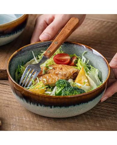 A close-up of a bohemian soup bowl filled with salad, chicken, and broccoli, with a fork resting beside. A close-up of a bohemian soup bowl filled with salad, chicken, and broccoli, with a fork resting beside.