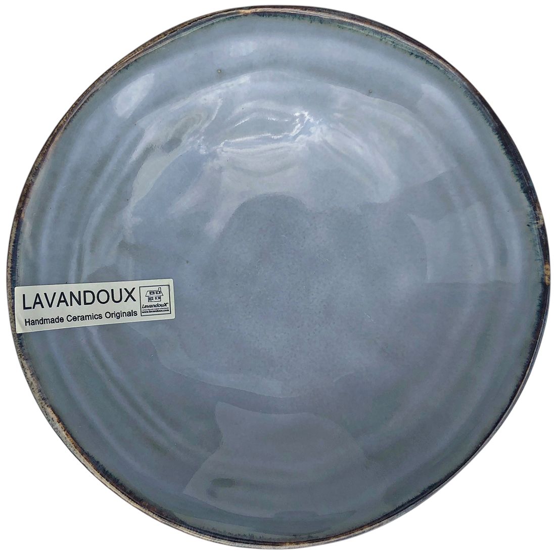 Bovenaanzicht van een van de tapas schaaltjes blauw gekleurd met een glanzende afwerking en een rustieke rand.