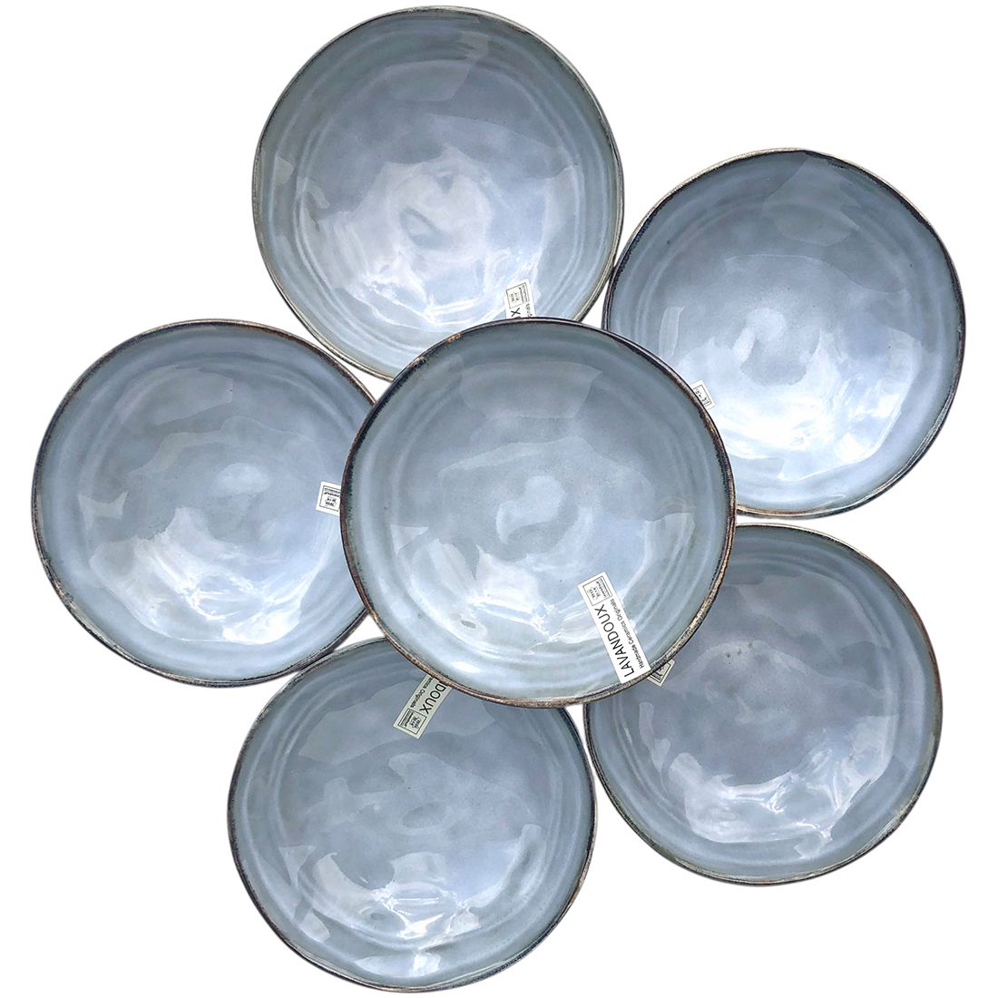 Een cirkelvormige opstelling van zes tapas schaaltjes blauw gekleurd met een glad glazuur.