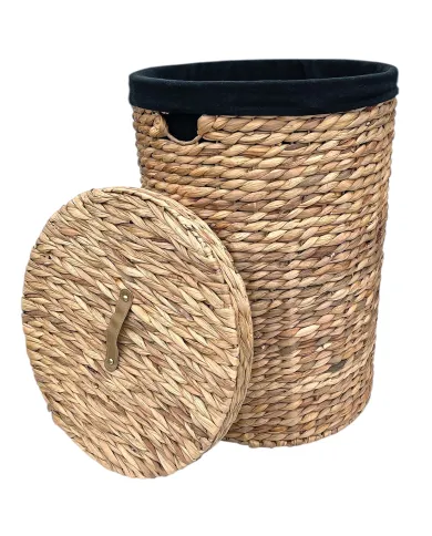 A round water hyacinth laundry basket with black fabric lining and a matching lid.