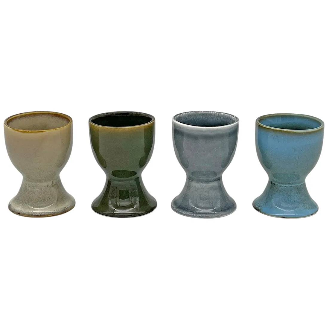 Four ceramic egg cups with a reactive glaze finish, arranged side by side. Four ceramic egg cups with a reactive glaze finish, arranged side by side.