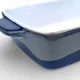 A close-up of an oven dish featuring a smooth white interior and a reactive glaze exterior.