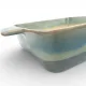 A close-up of a square oven dish high-lighting the reactive glaze finish.
