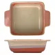 A square oven dish with a terracotta and cream gradient, featuring two handles for easy handling.