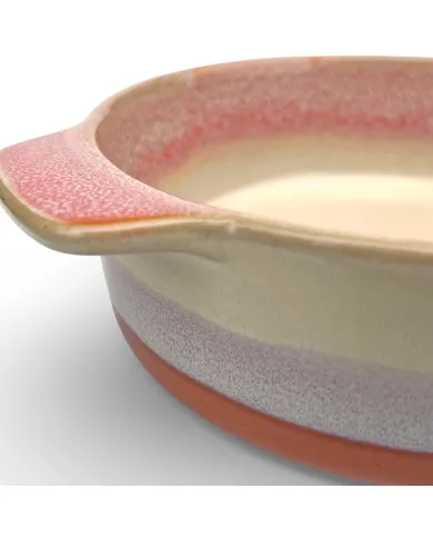 A close-up of a round oven dish high-lighting the reactive glaze finish.