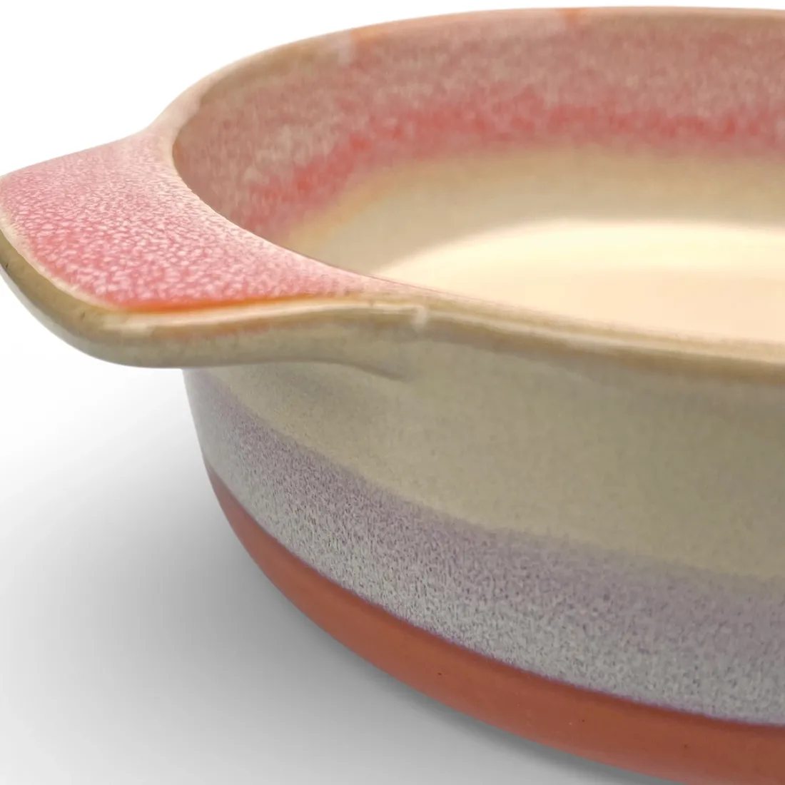 A close-up of a round oven dish high-lighting the reactive glaze finish.