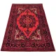 Traditional red rug in a Persian style with intricate patterns.