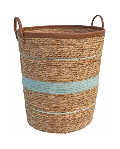 Round laundry basket made from seagrass with blue stripes and faux leather handles.