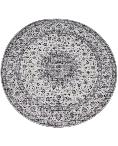 Round vintage style area rug with intricate floral patterns in shades of grey.
