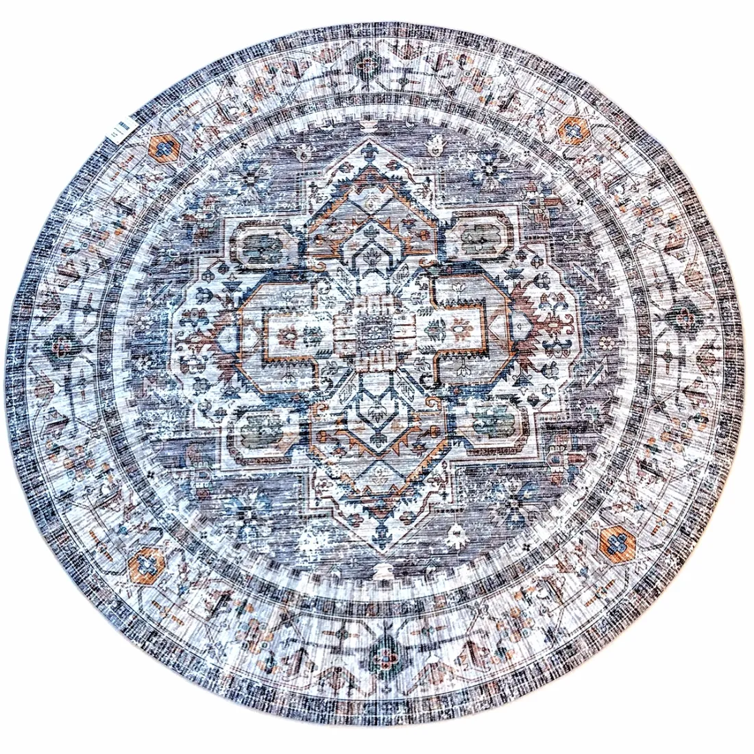 Round grey rug with intricate grey and blue patterns on a faded background.