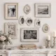 Wall with vintage photo frames displaying black and white photos and floral art.