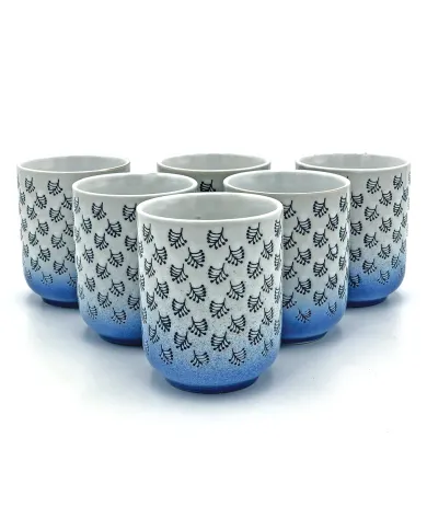 A collection of six white & blue mugs with dark blue leaf patterns and a blue gradient at the bottom.