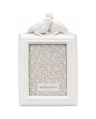 White picture frame with decorative birds on top in a vintage style.